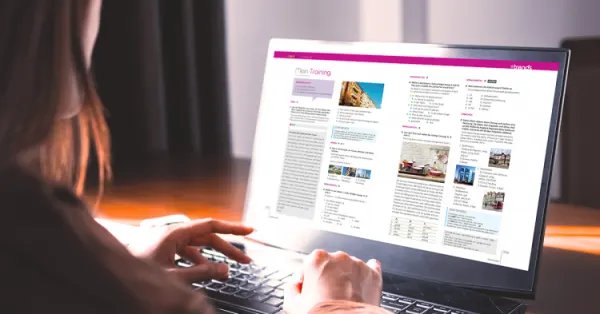 Ekran laptopa z podręcznikiem do języka niemieckiego.